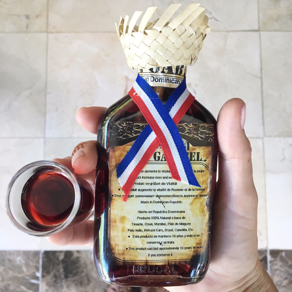 Dominican Brugal bottle with a hat and small glass