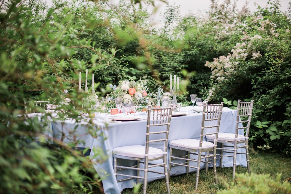 Romantic outdoor table setting with flowers and candles