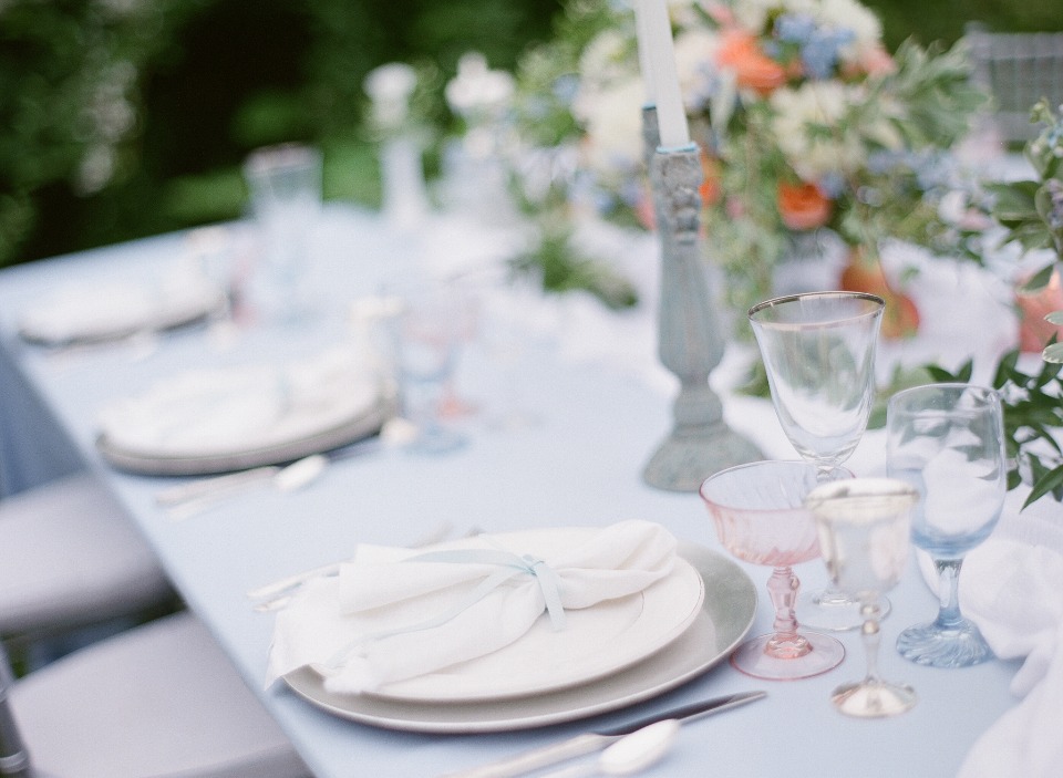 Soft blue elegant table setting for an outdoor event