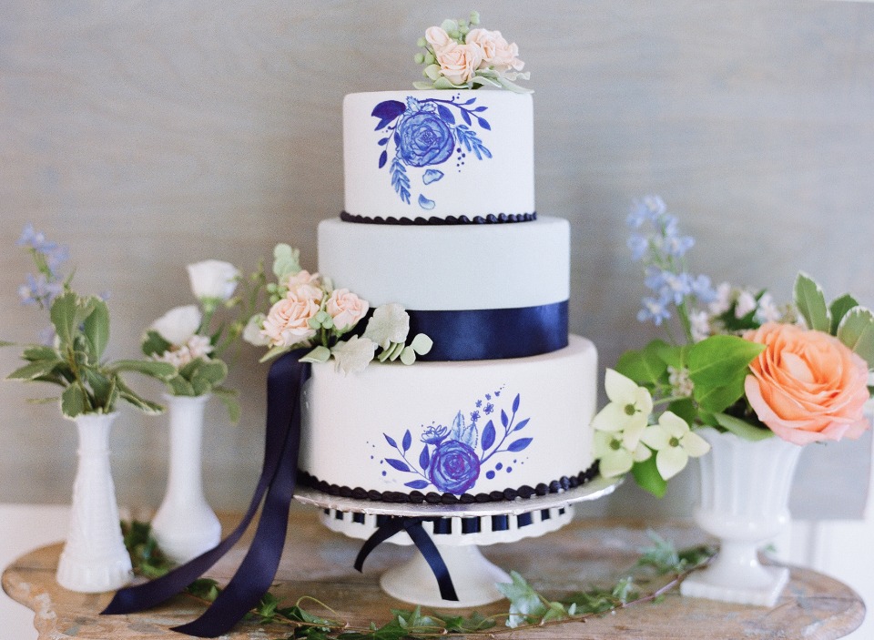 Elegant tiered wedding cake with blue floral design