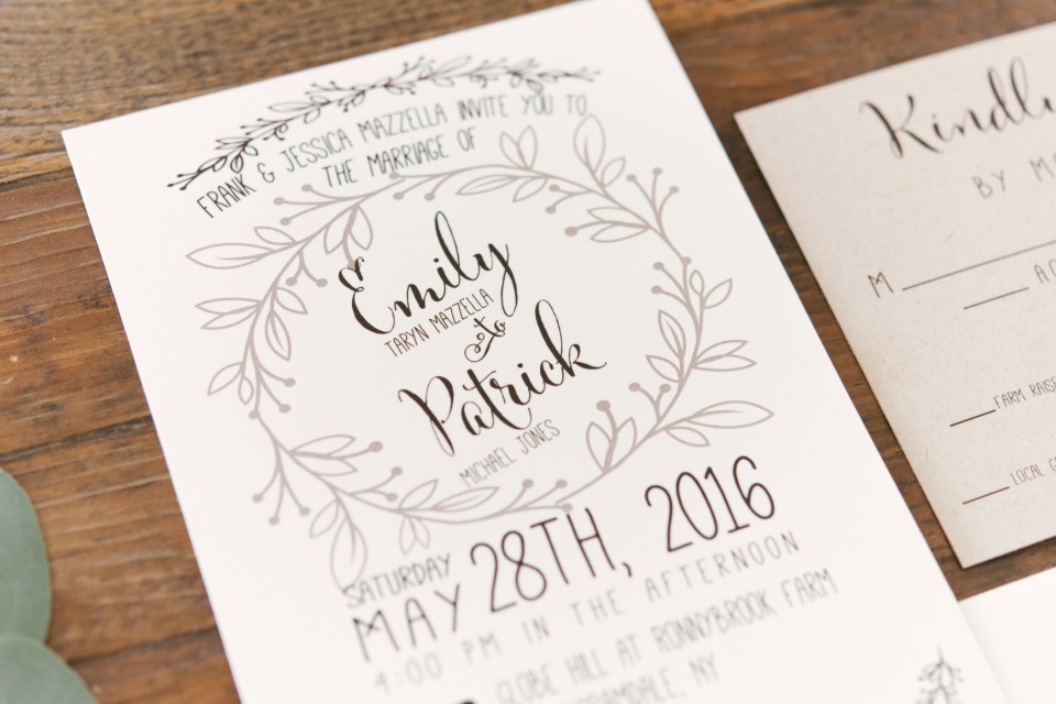 Wedding invitation design with floral wreath and elegant script