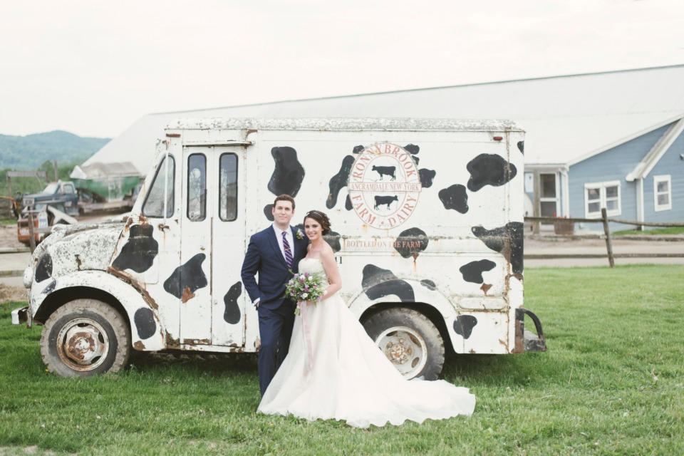 Bride and groom at Roxbury Barn wedding venue with milk truck