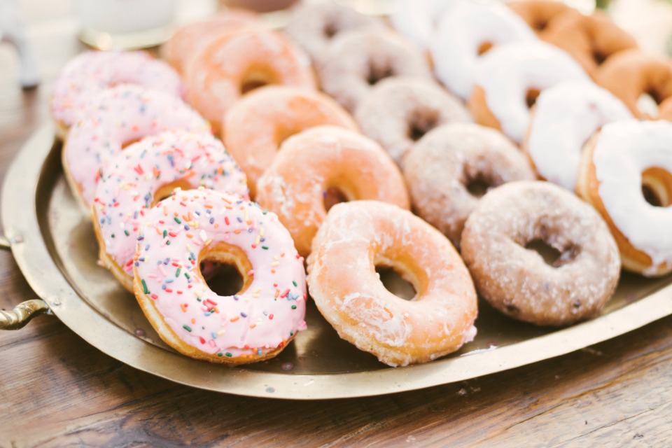 Delicious assortment of donuts on a gold platter for a sweet treat