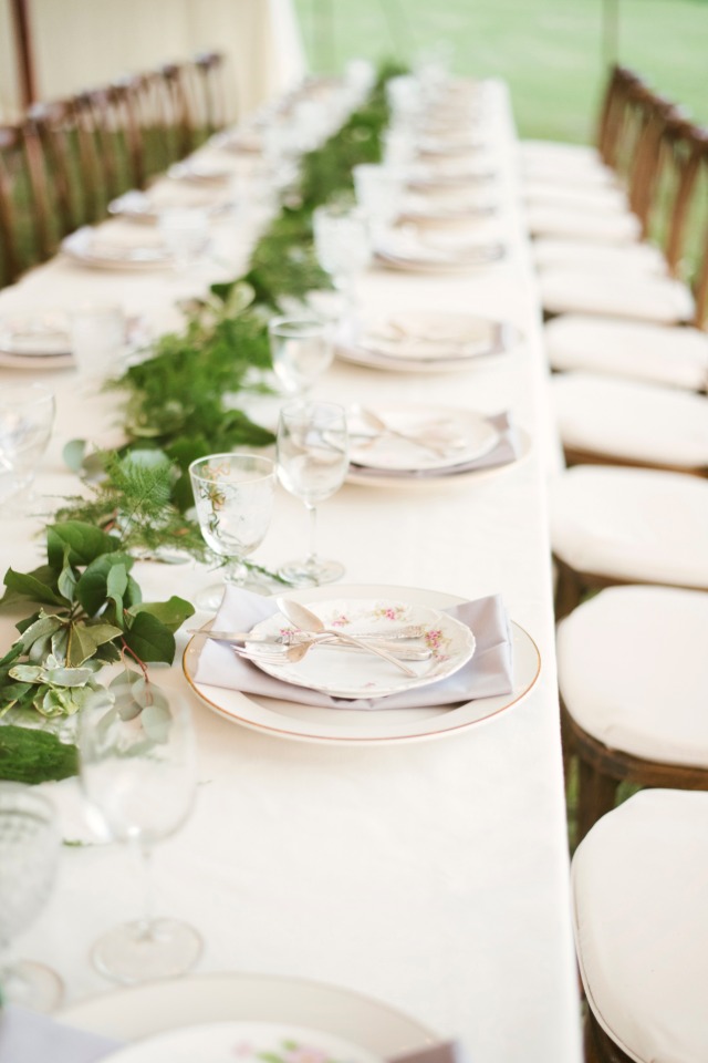 Elegant table setting with floral plates and green garland