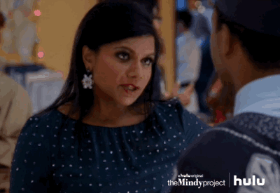 Woman in sparkly dress appears nervous, clutching her throat