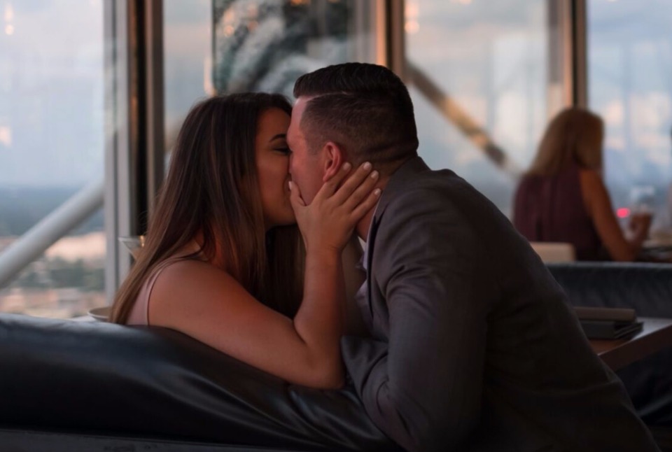 Romantic couple sharing a kiss at a restaurant