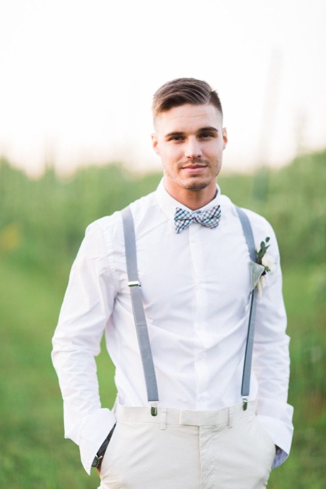 groom in dusty blue suspenders and bow tie