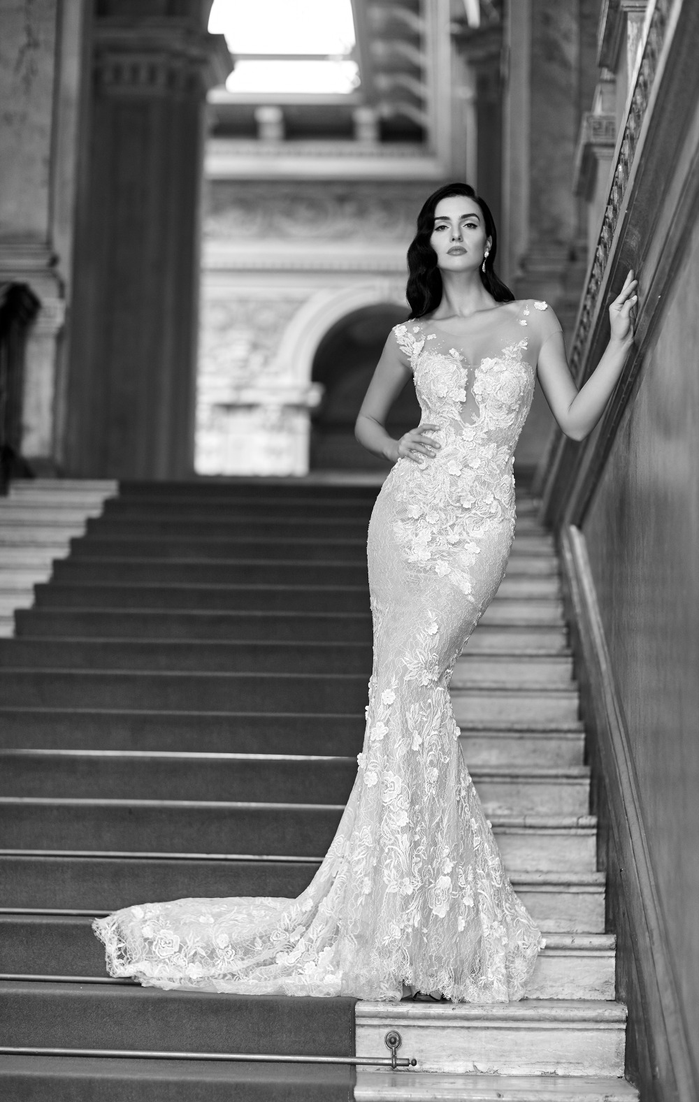 Bride in floral lace gown on grand staircase in black and white