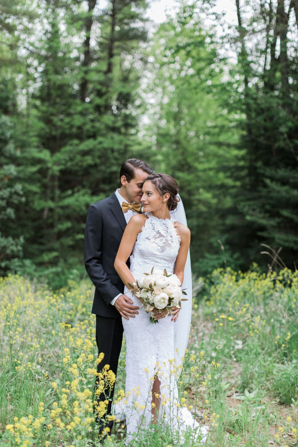 Bride and groom embrace in a wildflower field wedding