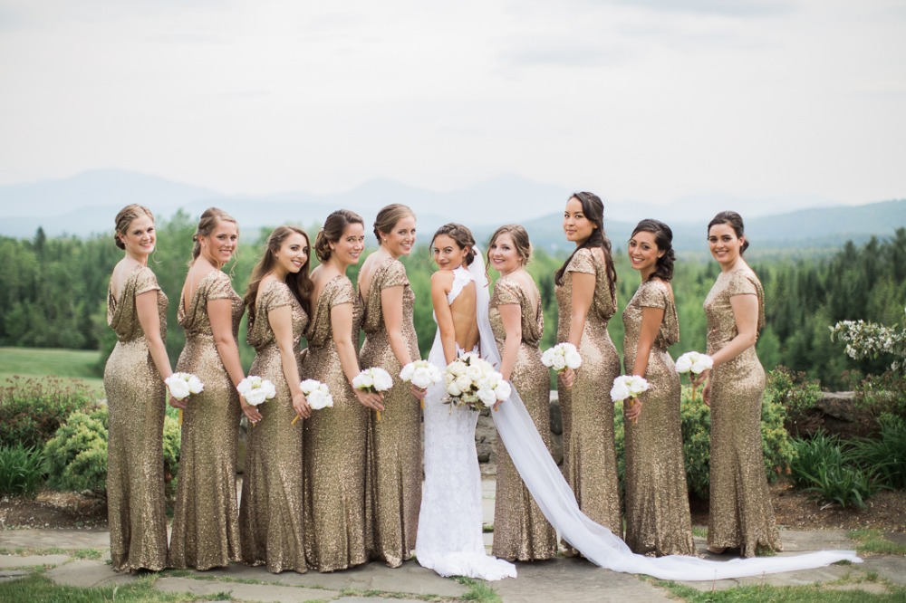Bride and bridesmaids in gold sequin dresses smiling