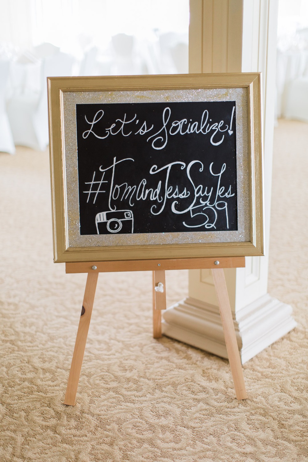 Wedding sign inviting social media interaction, hashtags included