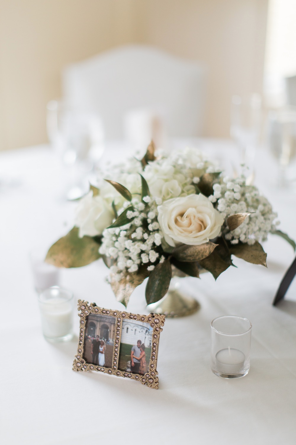 Elegant wedding table decor with flowers and framed photos