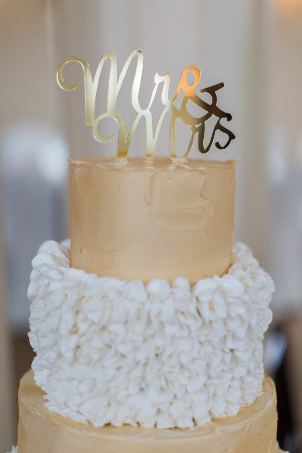 Elegant wedding cake with Mr and Mrs topper in gold