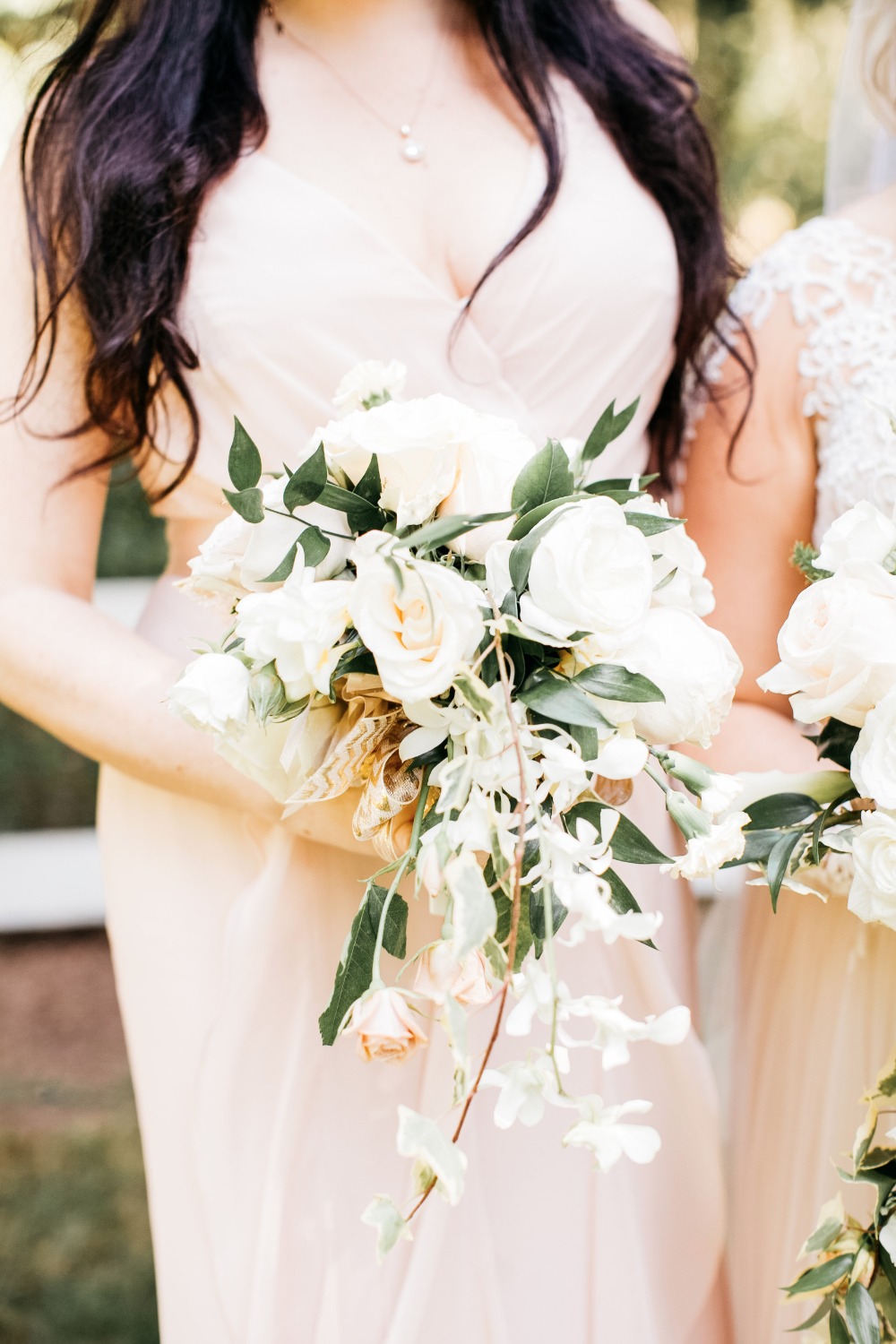 Elegant cascading bridal bouquet with white roses and greenery