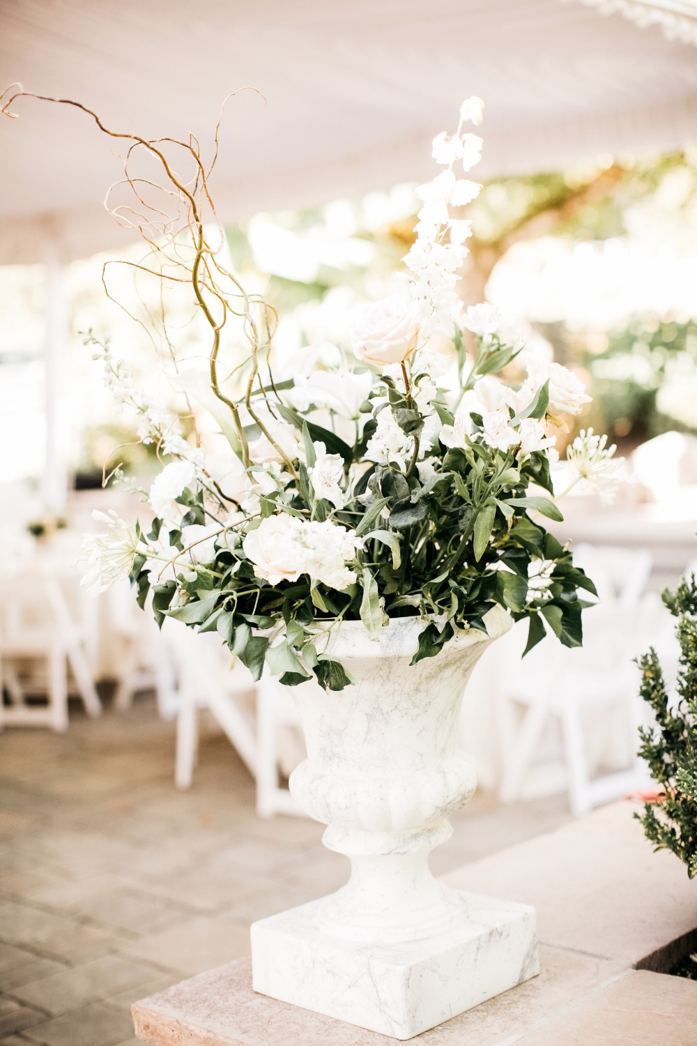 Elegant white flower arrangement in classic stone urn