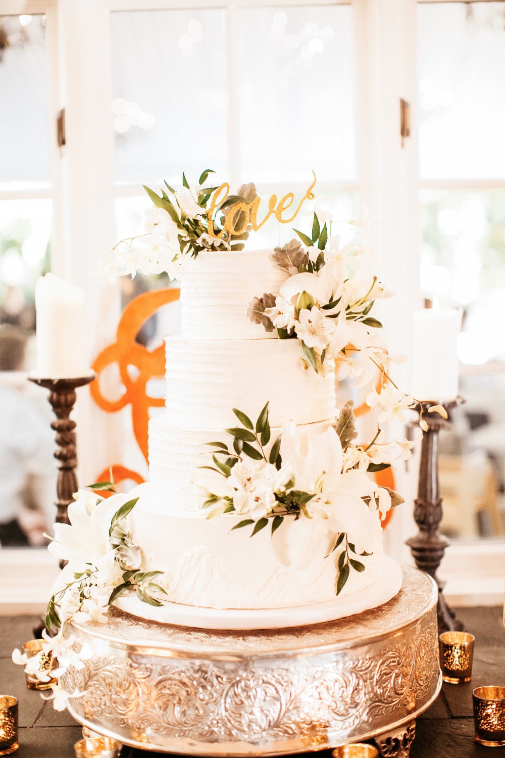 Beautiful white wedding cake with white florals