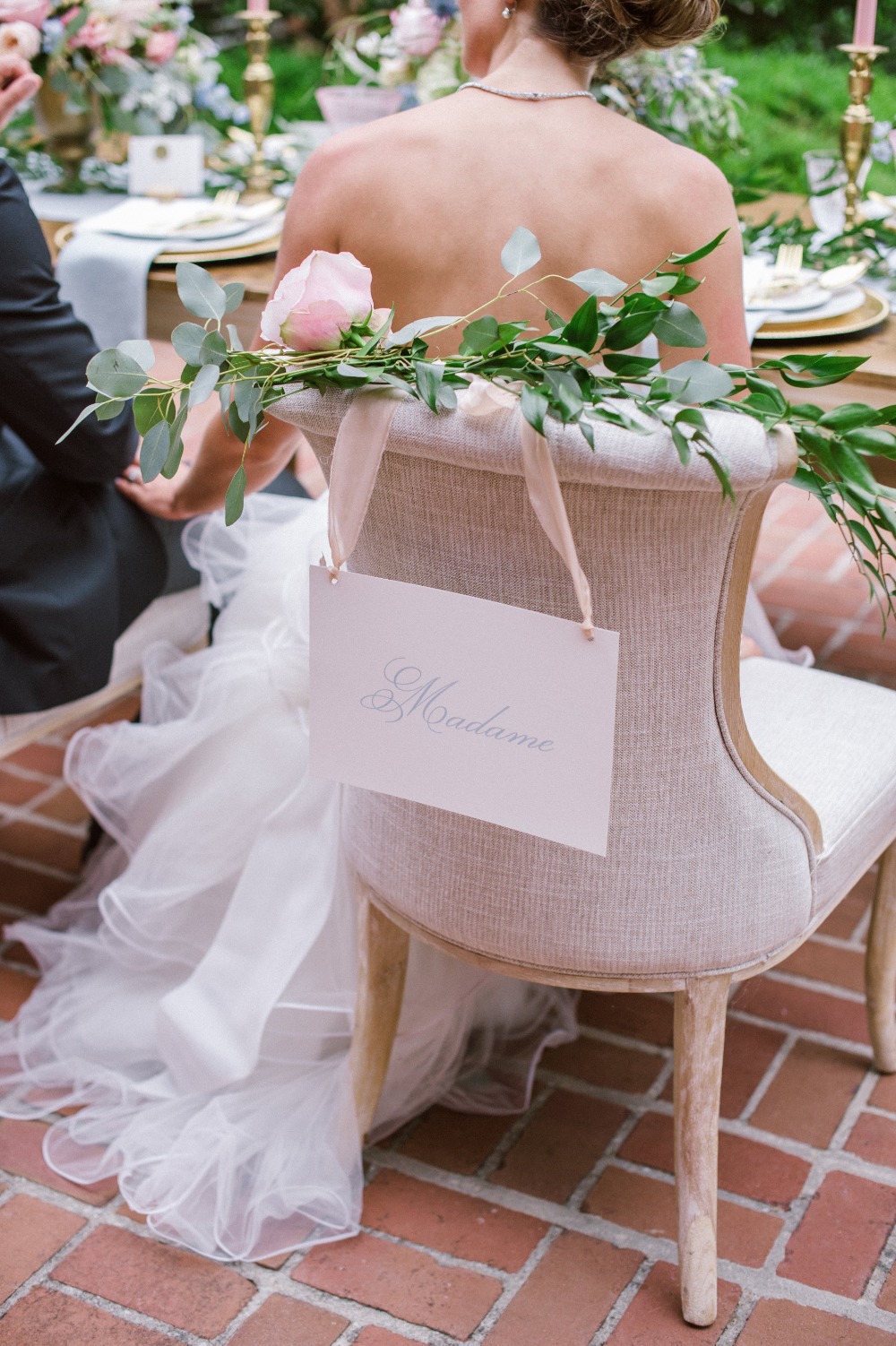 Madame brides wedding seat sign with flower garland draped chair
