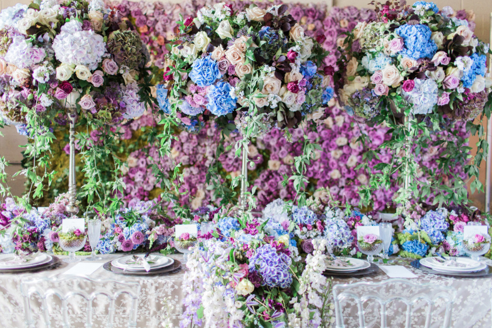 beautiful purple and blue flower filled wedding reception