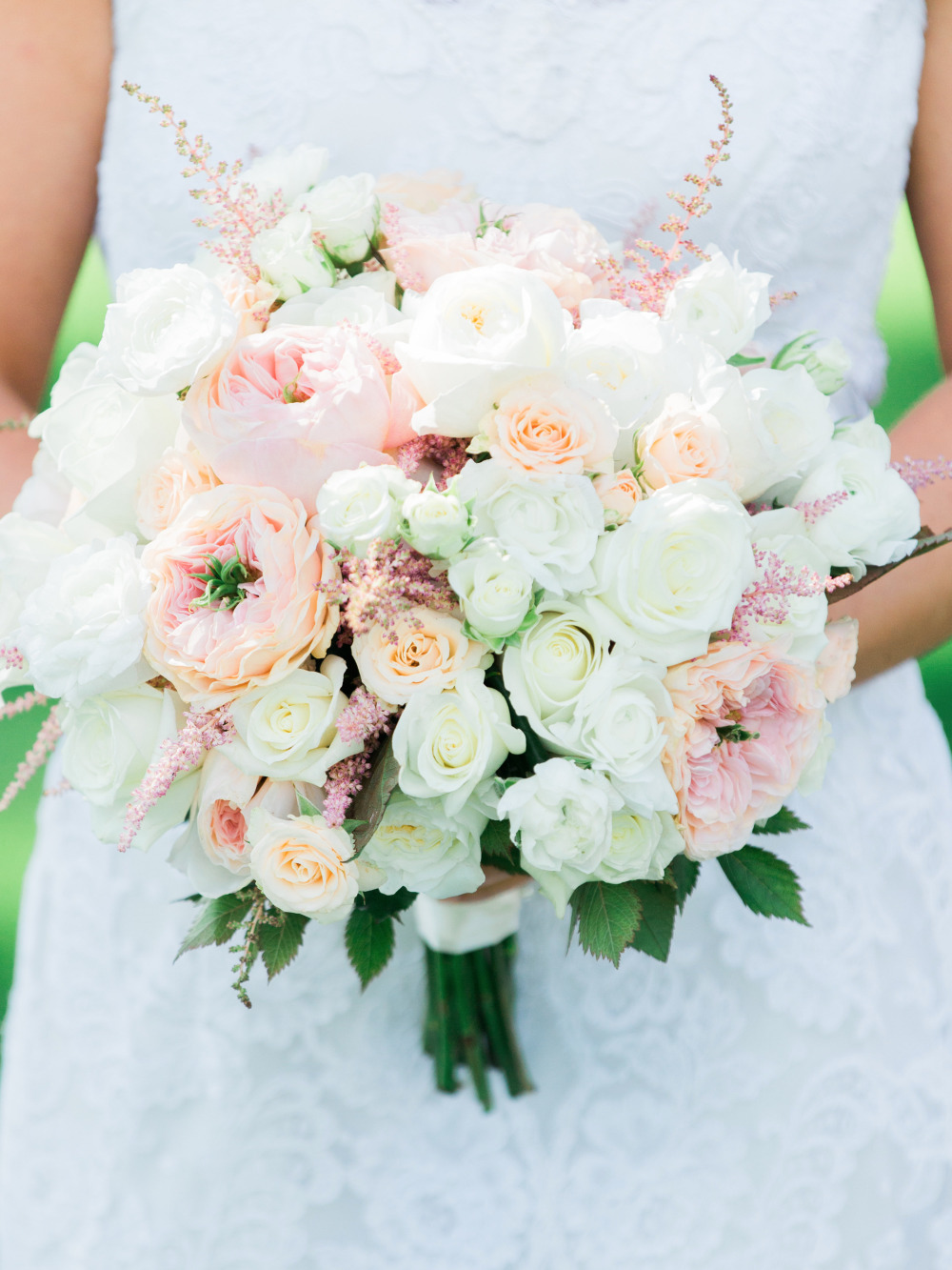 Bridal bouquet with peach and white roses and greenery