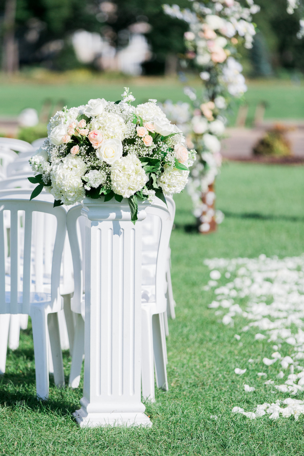 Wedding ceremony floral arrangement on white column