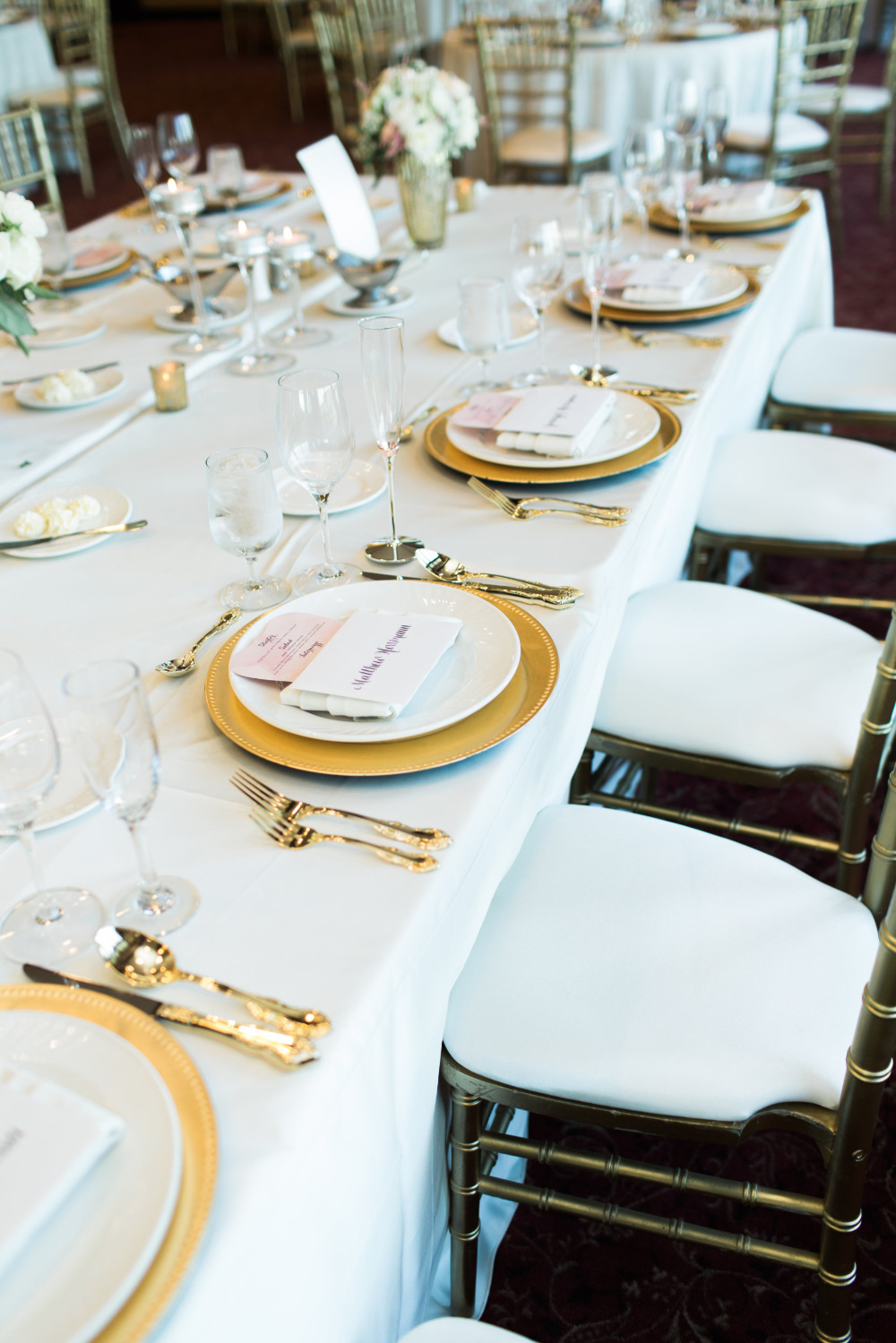 Elegant wedding reception table setting with gold accents