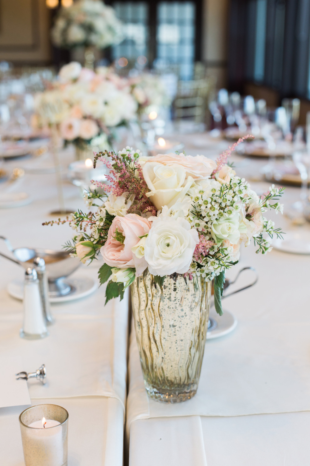 pink and white centerpiece in mercury glass