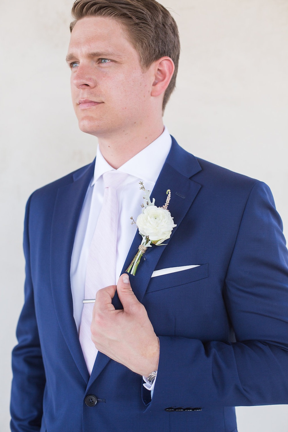 groom in blush pink tie and navy suit