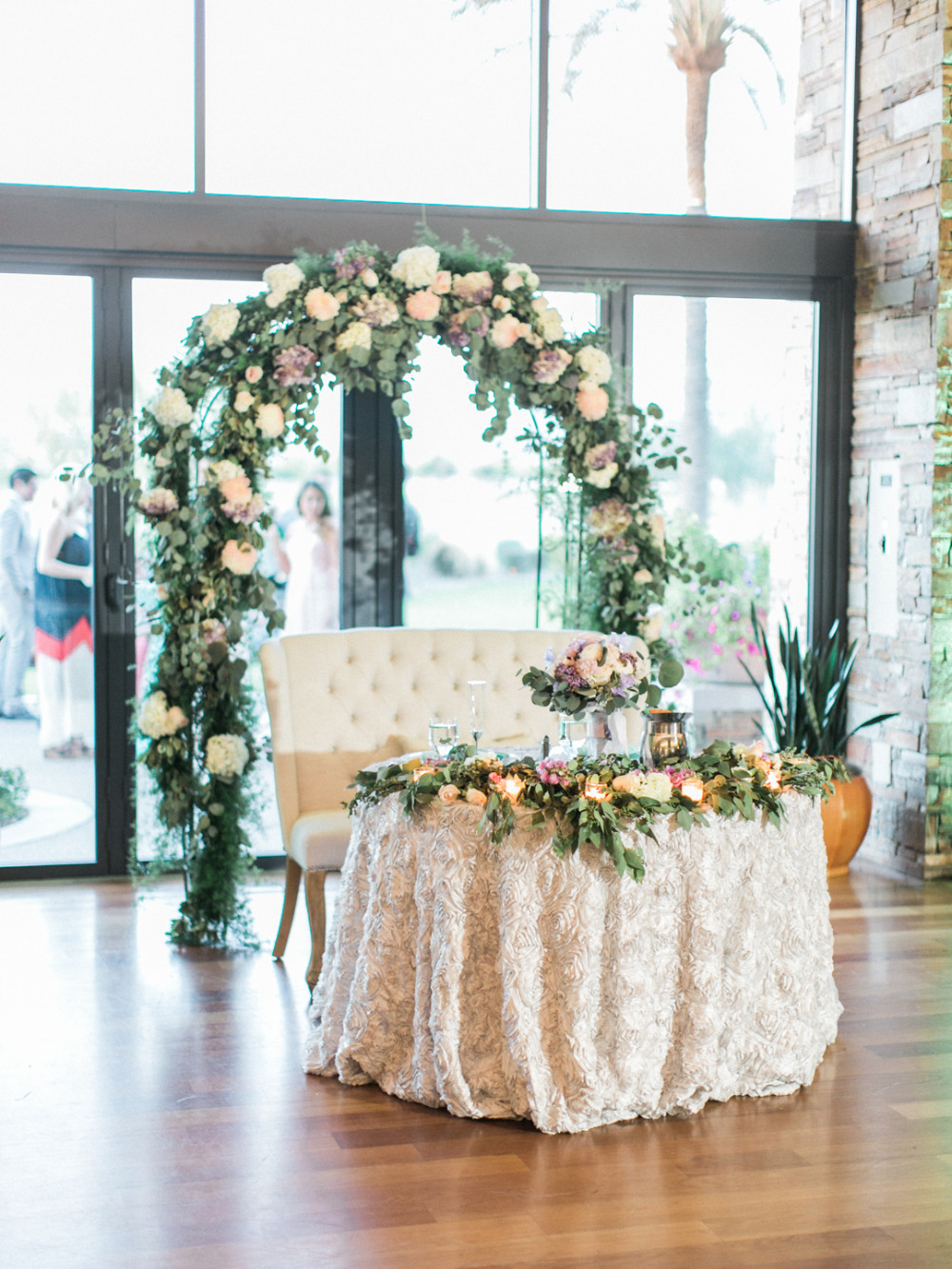 sweetheart table with flower arch