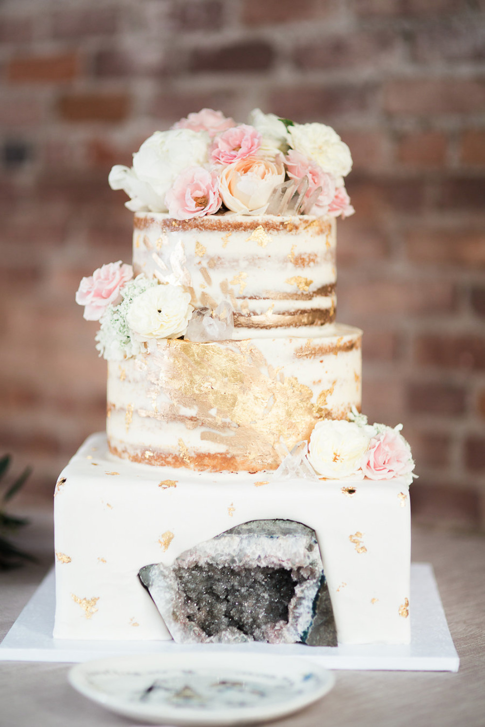 naked wedding cake with gold foil and geode