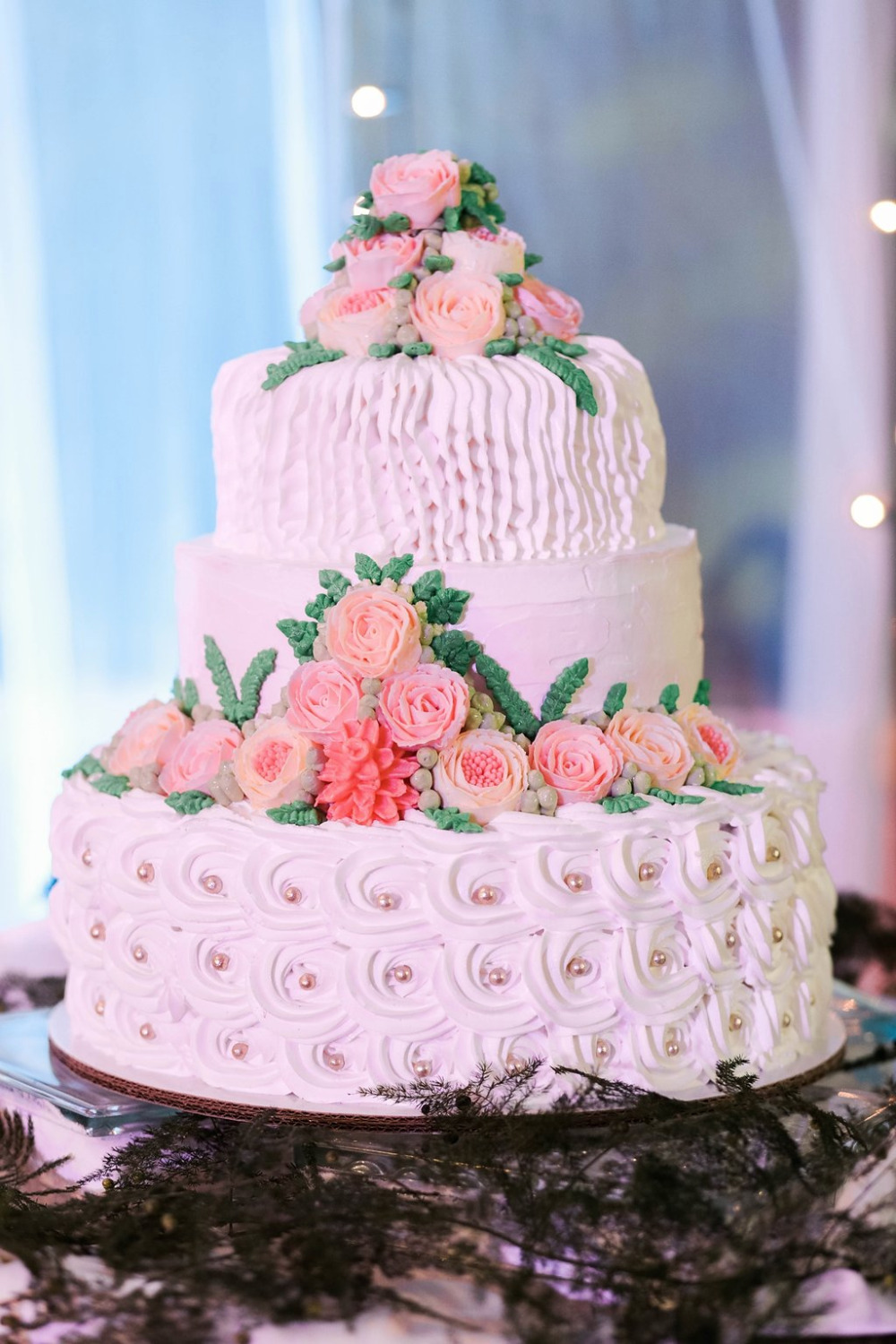 white and pink wedding cake made by the bride