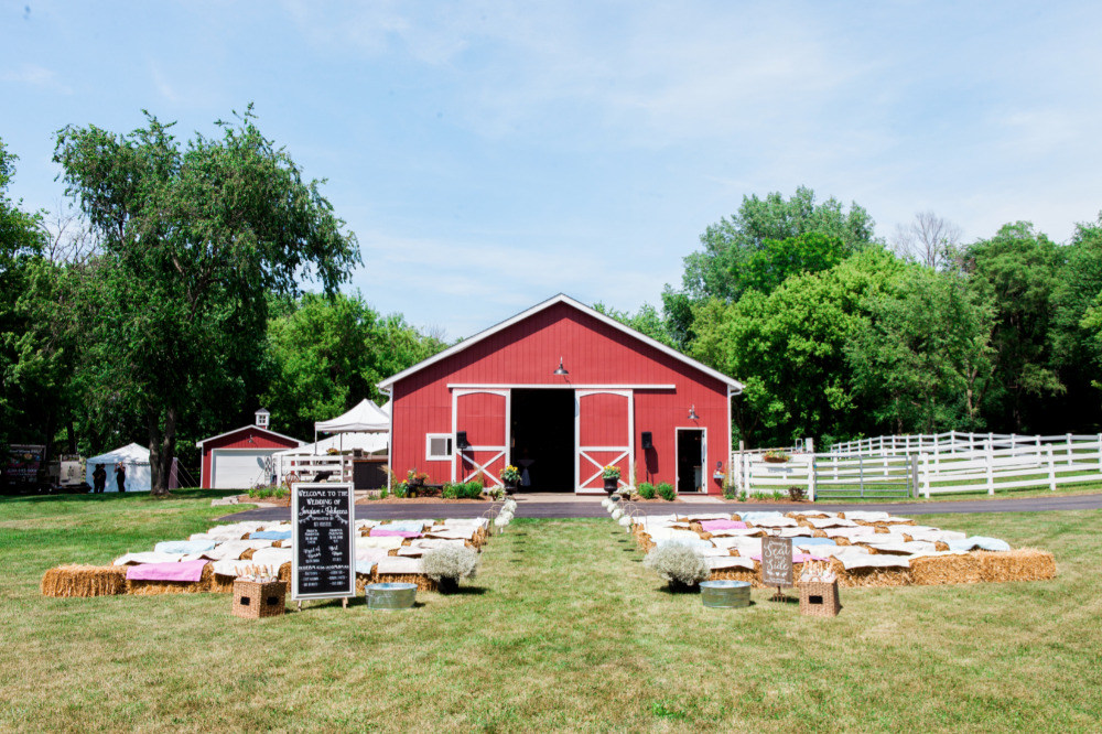 farm barn wedding ceremony with hay bales