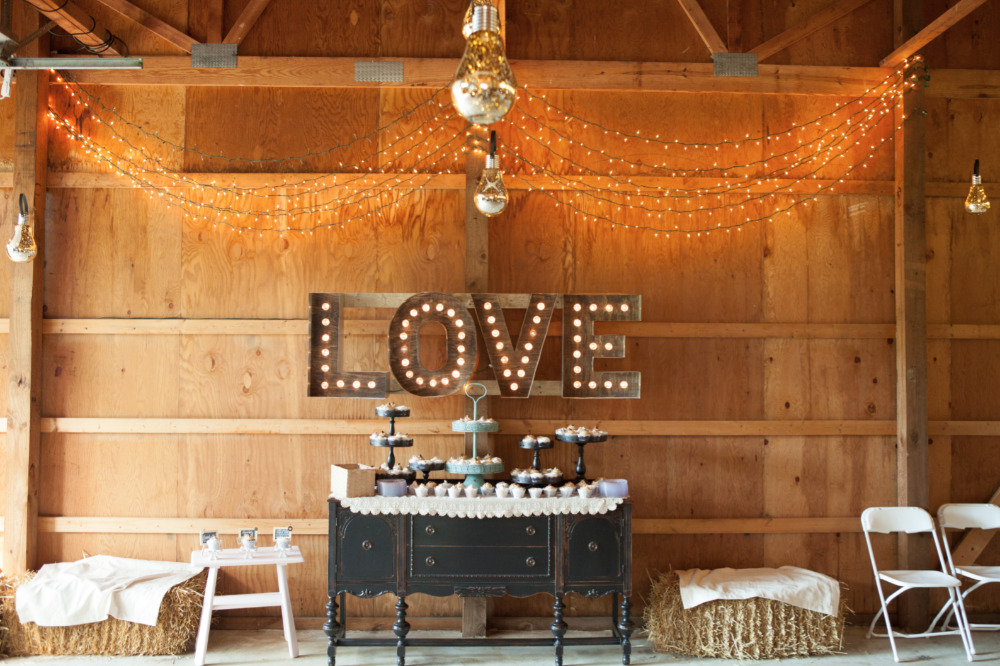 Rustic barn wedding with LOVE sign and dessert table