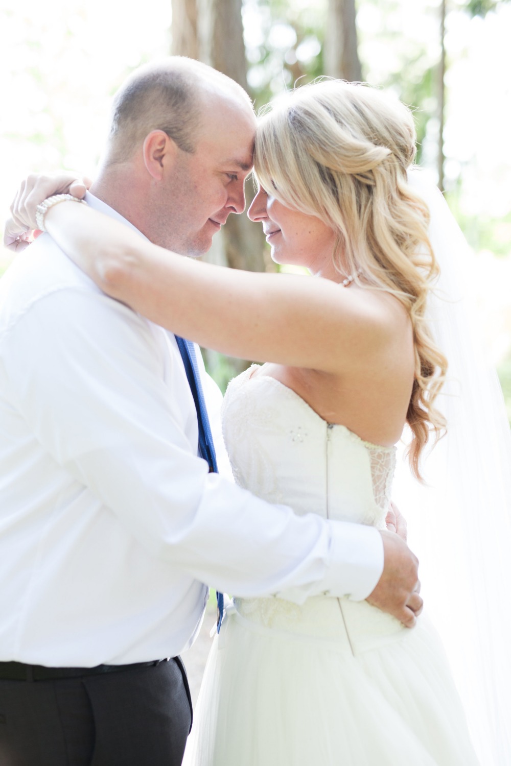 Happy newlyweds embracing tenderly on their wedding day