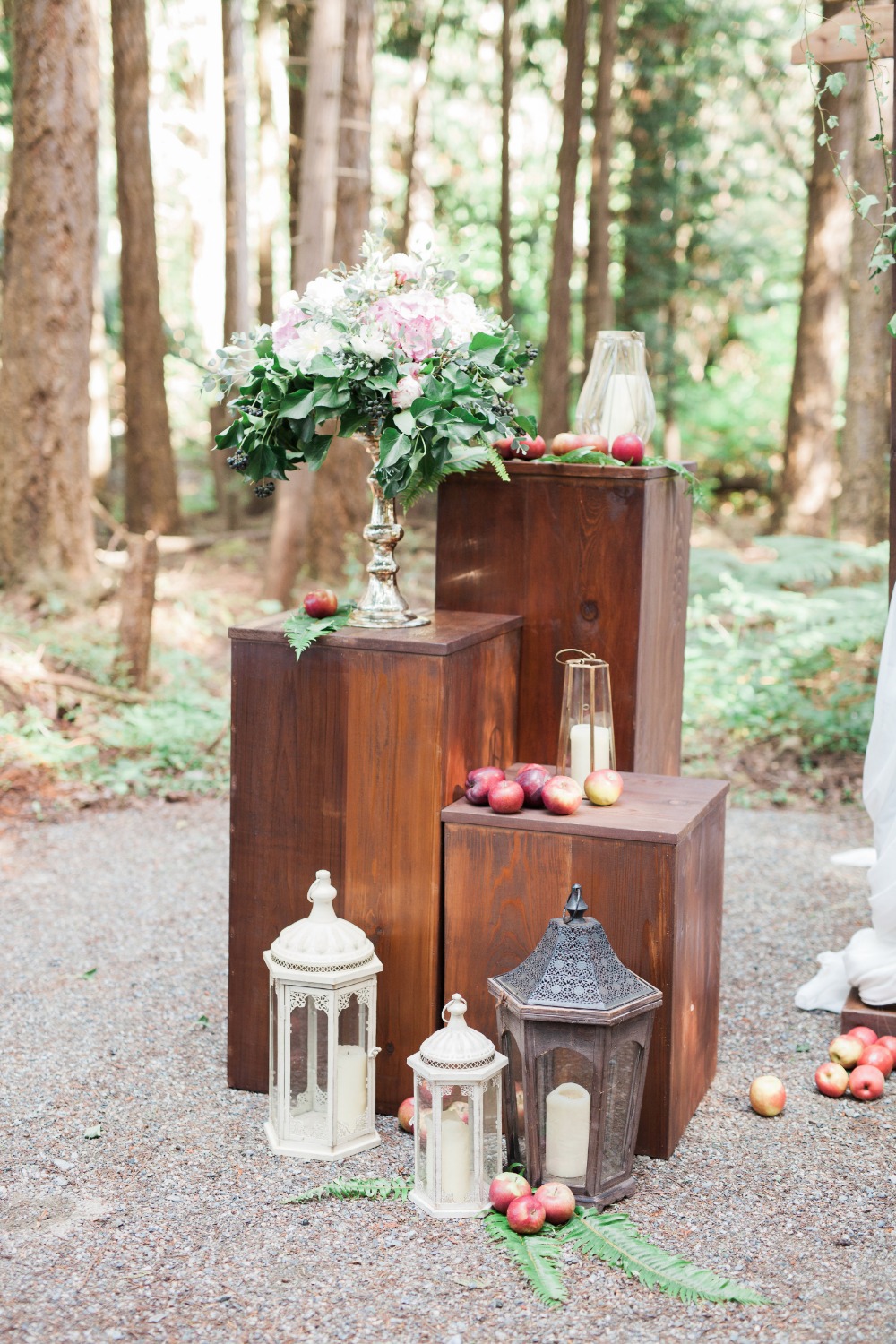 Forest wedding decor with lanterns apples and flowers