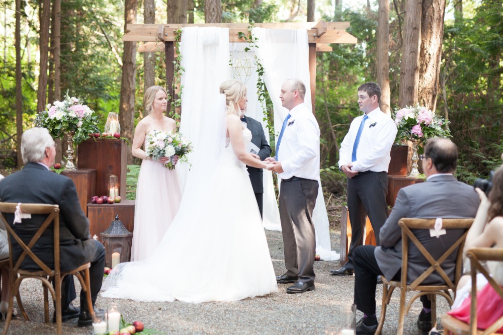 Outdoor wedding ceremony with bride and groom exchanging vows