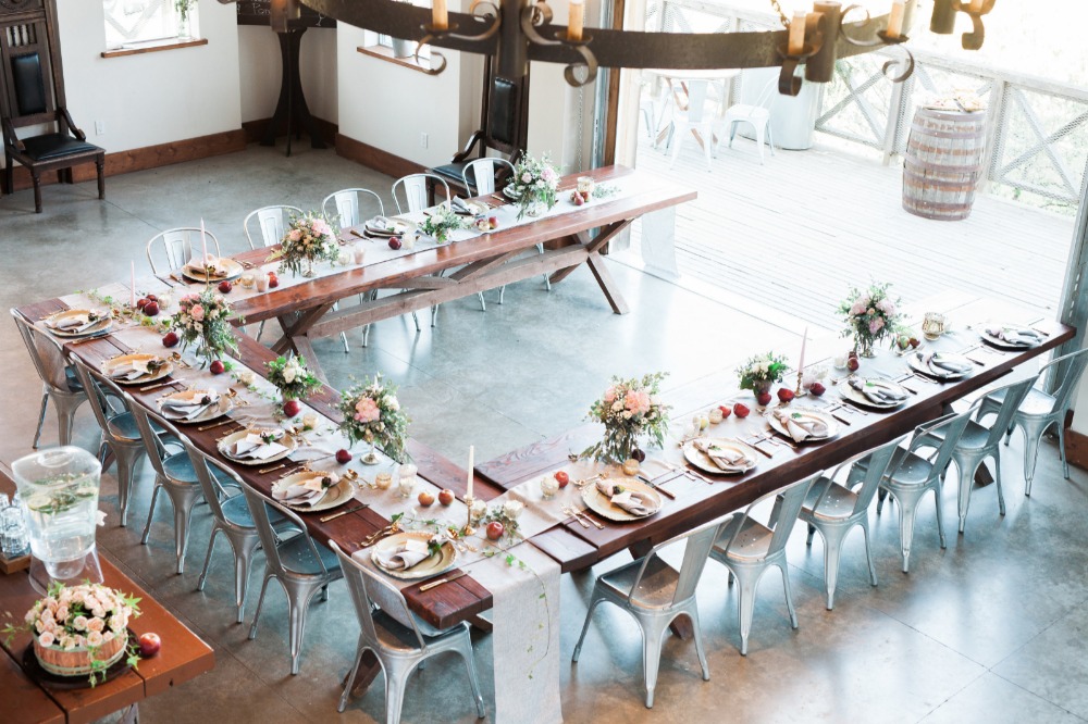 Rustic wedding reception with long wooden tables decor
