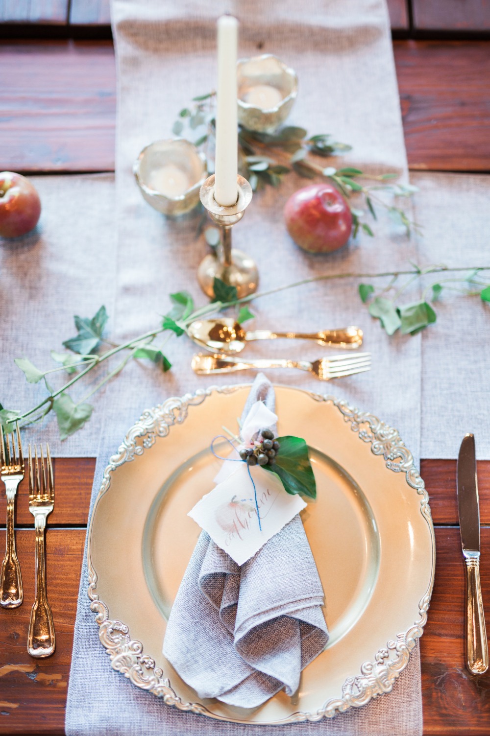 Elegant rustic table setting with candles and apples