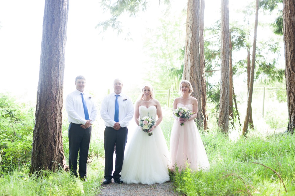 Wedding party in a forest; bride, groom, and bridesmaids