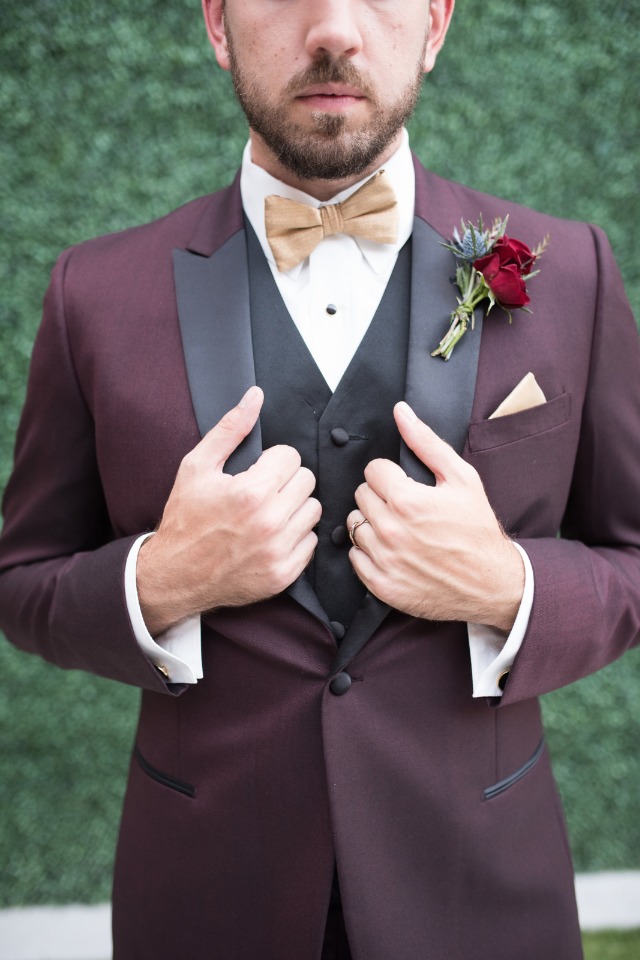 gold bow tie with maroon and black three piece suit