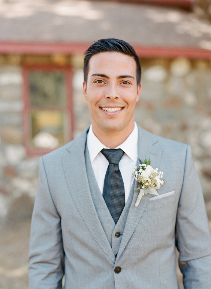 groom in light grey suit and charcoal tie