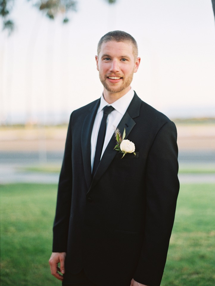 Smiling groom in a black tuxedo ready for his wedding ceremony