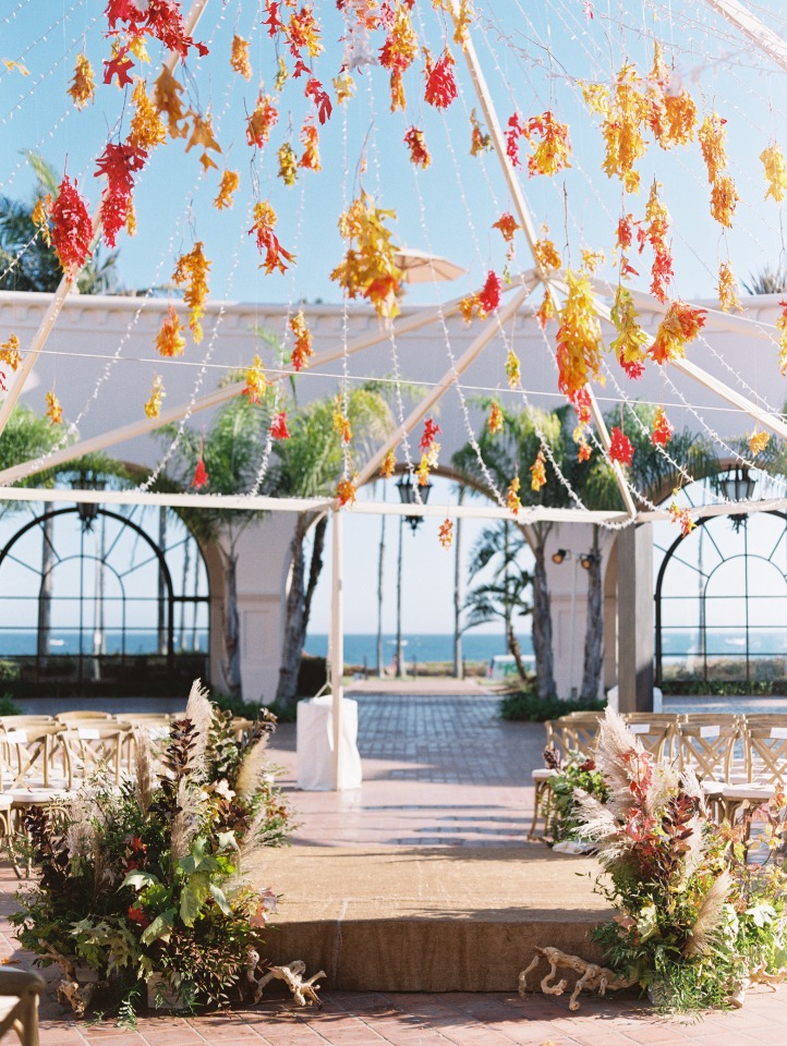 Wedding ceremony with colorful floral decor and ocean view