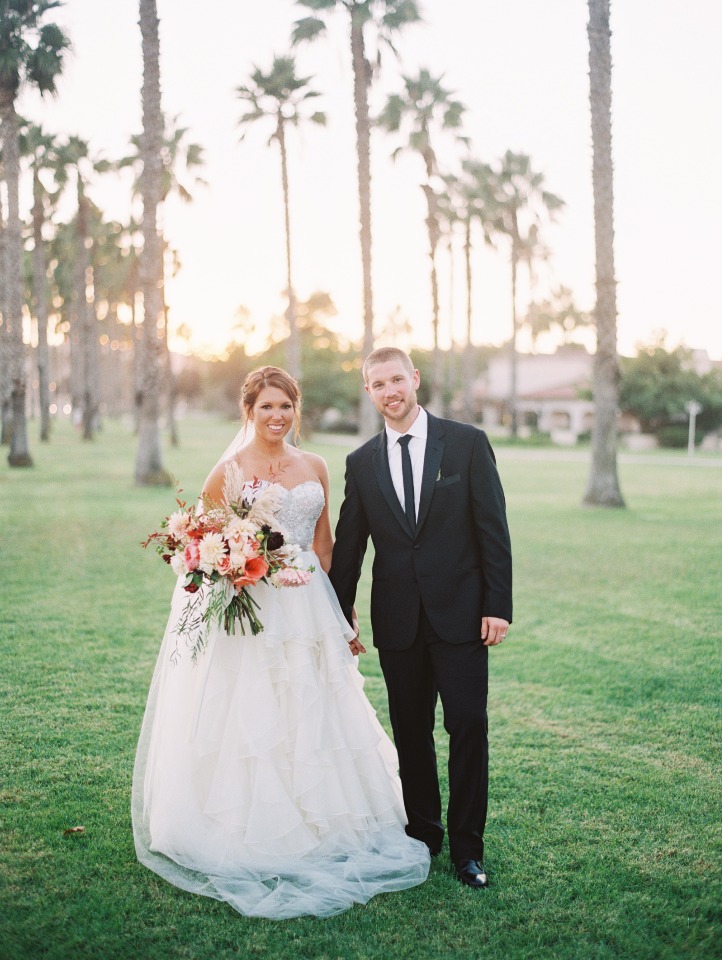 Happy couple posing on their wedding day in a beautiful outdoor setting