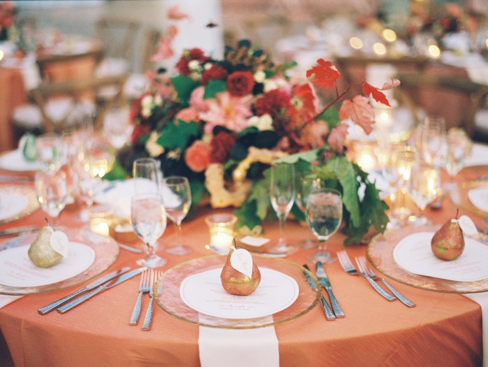 Elegant wedding table setting with pear decor and floral arrangement