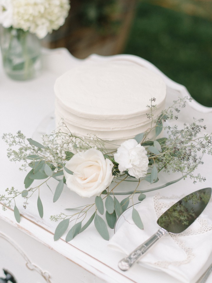 simple white and eucalyptus accented wedding cake