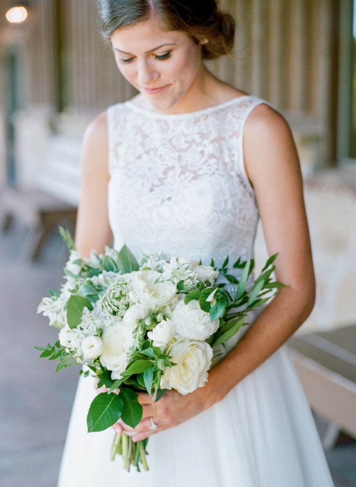 Elegant bride holding beautiful white wedding bouquet
