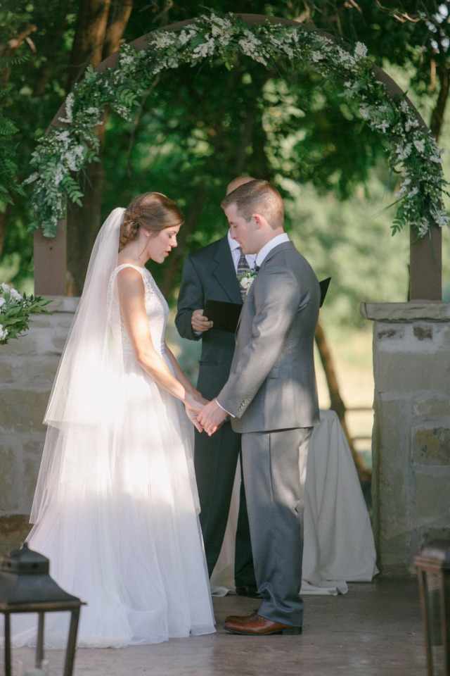 Bride and groom holding hands during wedding ceremony