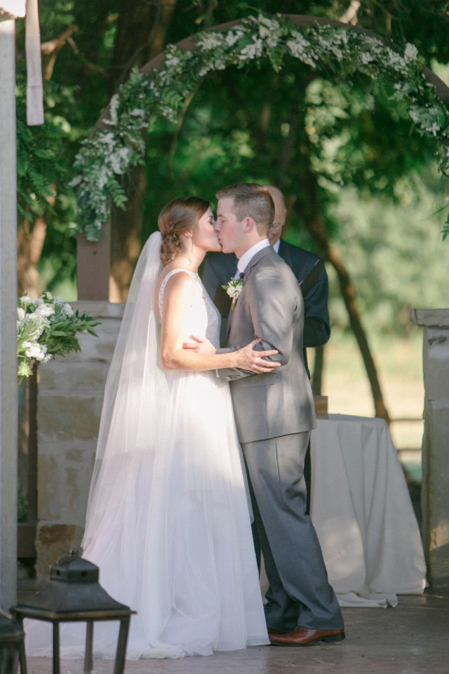 Bride and groom sharing a kiss at their wedding ceremony