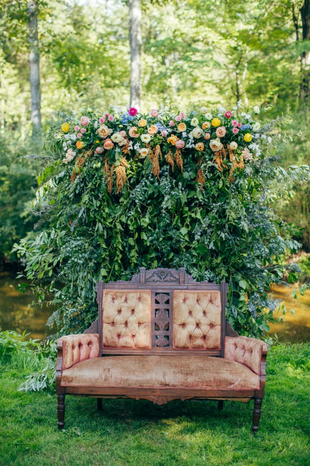 Vintage wedding lounge area with floral backdrop