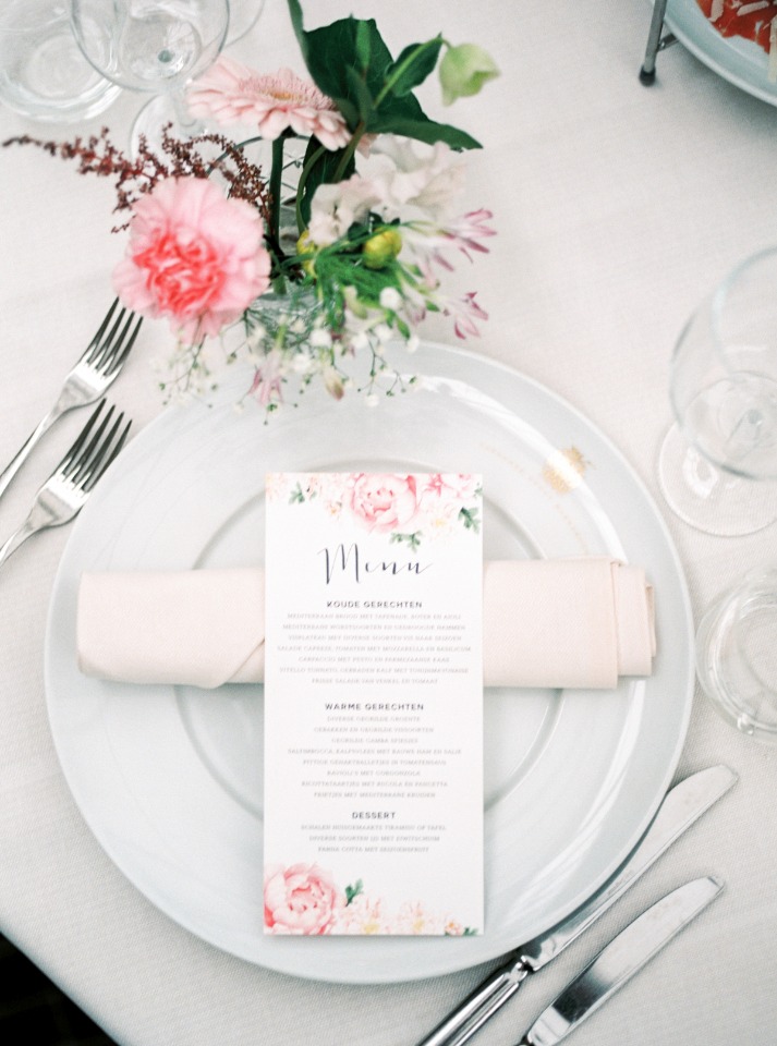 flower accented wedding menu and simple place setting